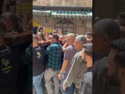 Making way for worshipers carrying the cross at via Dolorosa in Jerusalem